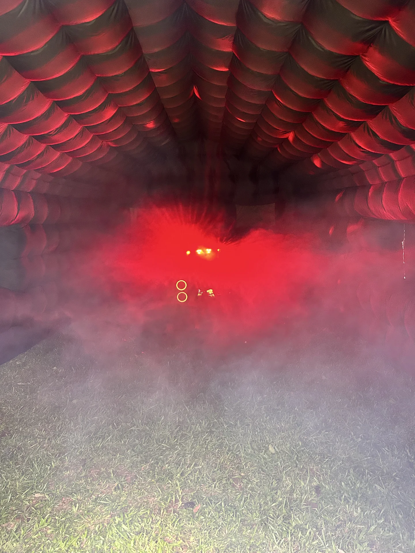 Red and blue party lighting illuminating the inflatable nightclub interior