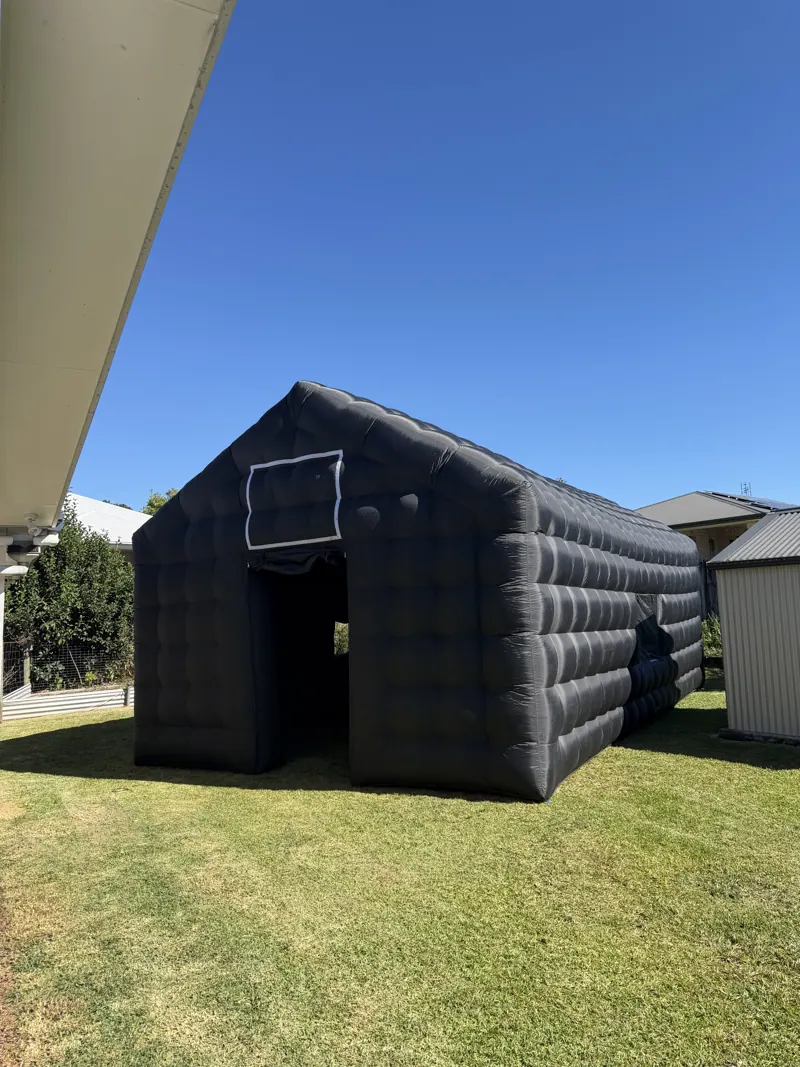 Cove inflatable nightclub set up on a lawn beside a house