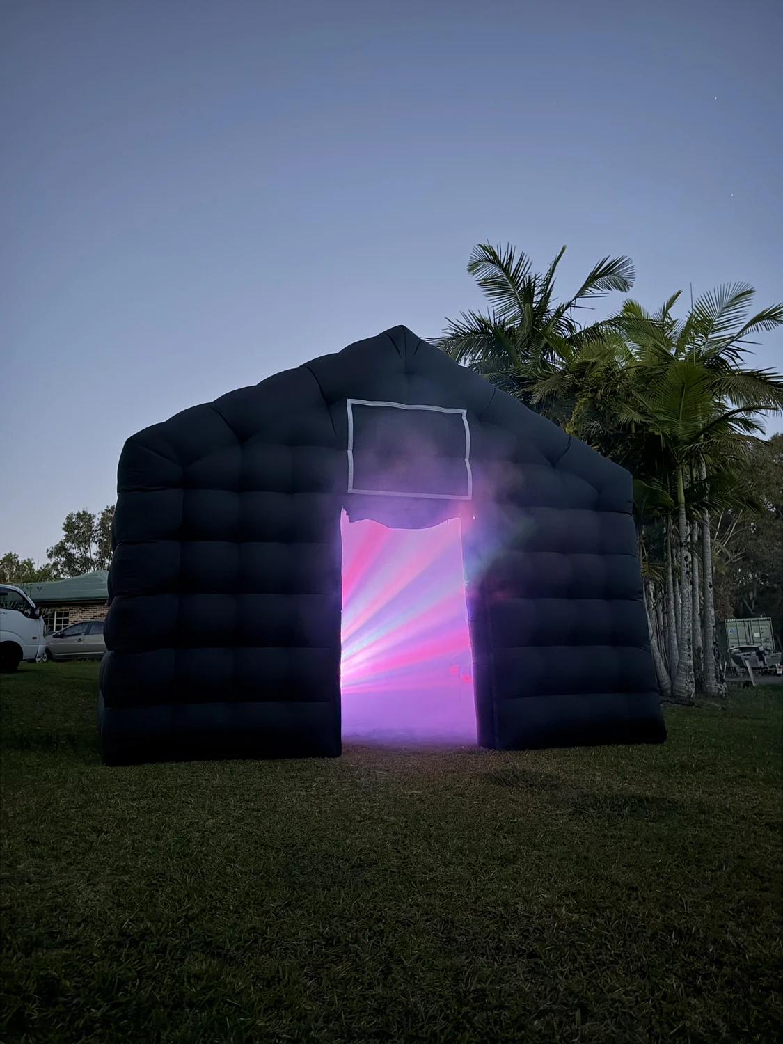 Black inflatable nightclub with pink and purple party lighting